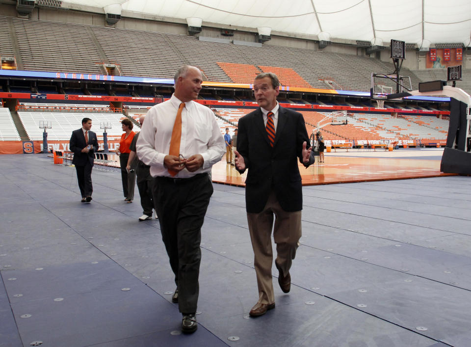 FILE - In this July 12, 2016, file photo, Syracuse University athletic director John Wildhack, right, talks with Syracuse University vice president and chief facilities officer Peter Sala, left, during a visit to the Carrier Dome in Syracuse, N.Y. Sala remembers the moment as if were yesterday, always will. It was the late 1970s, he was a high school student, and Syracuse University had decided to replace aging Archbold Stadium with an indoor facility featuring an air-supported roof. Sala's dad, John, was director of the university's physical plant, and brought some of the drawings of the future Carrier Dome home. (AP Photo/Nick Lisi, File)
