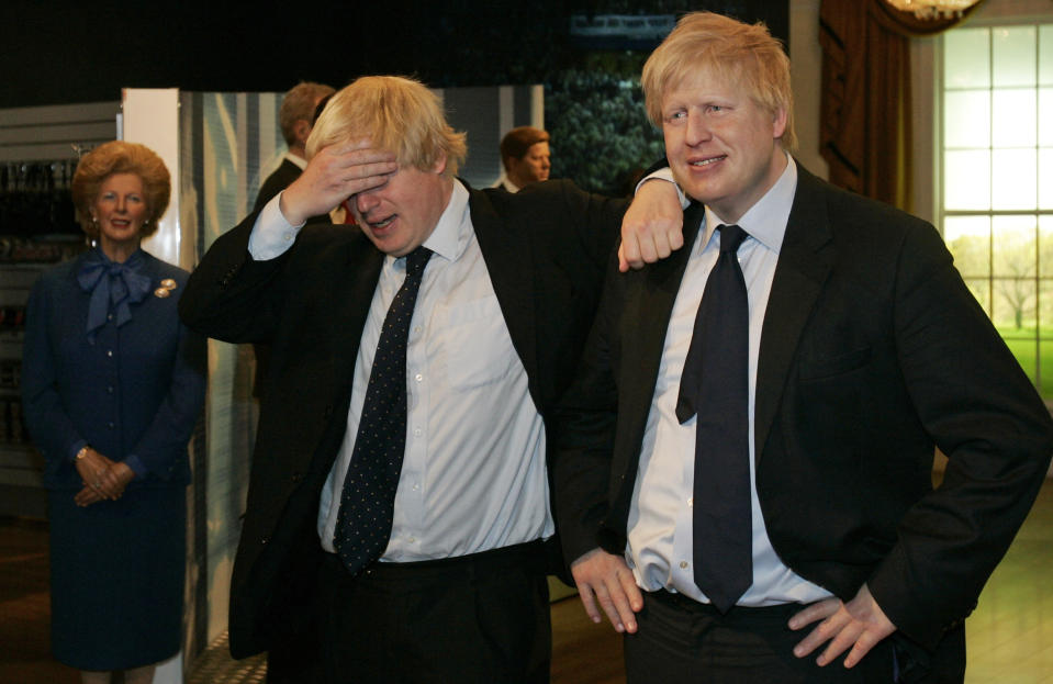 FILE - In this Tuesday, May 5, 2009 file photo then Mayor of London Boris Johnson, left, poses with a wax figure of himself at Madame Tussauds wax museum in London, after being introduced to his new wax figure. (AP Photo/Sang Tan, File)