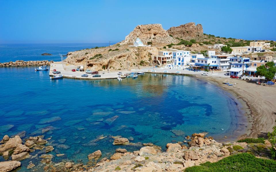 bay of water with a few blue and white houses - Getty Images