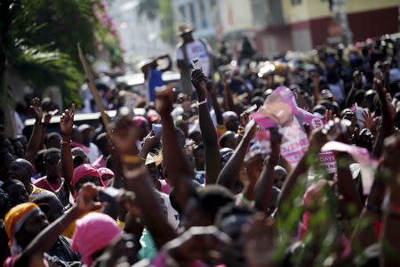 Supporters of PHTK political party react to a speech next to the Provisional Electoral Council building during a demonstration to demand the organization of a postponed presidential runoff election in Port-au-Prince, Haiti, April 24, 2016. REUTERS/Andres Martinez Casares