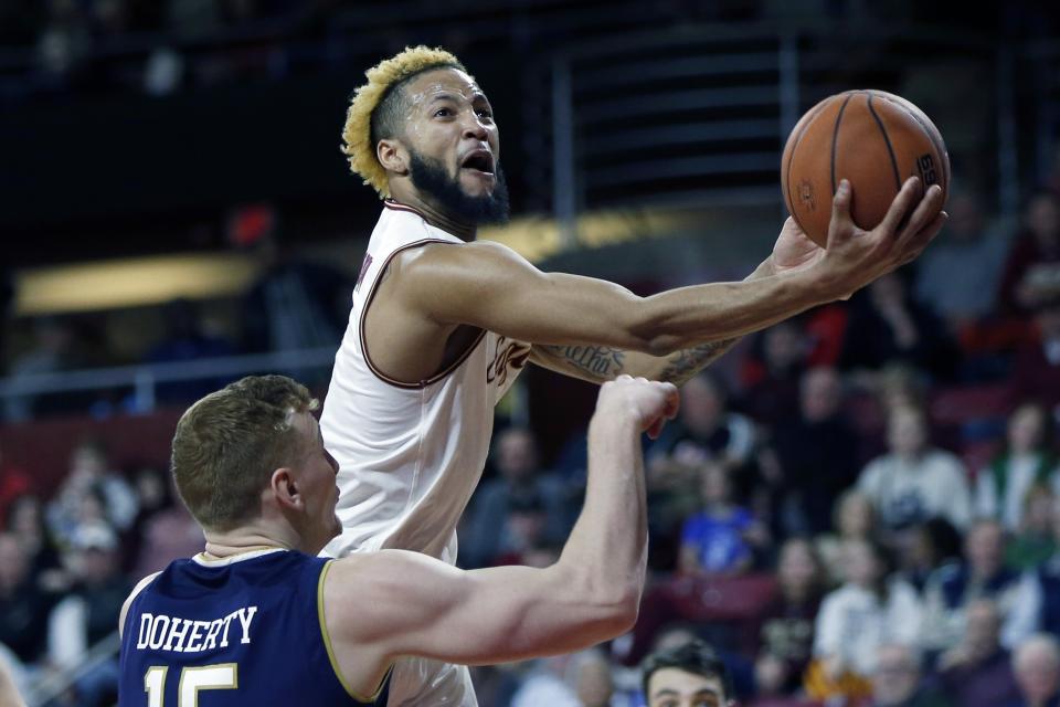 FILE - In this Feb. 2, 2019, file photo, Boston College's Ky Bowman shoots over Notre Dame's Chris Doherty (15) during the first half of an NCAA college basketball game, in Boston. Bowman was named to the AP All-ACC team, Tuesday, March 12, 2019.(AP Photo/Michael Dwyer, File)