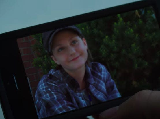 hand holding a smartphone displaying a photo of adam torres on degrassi