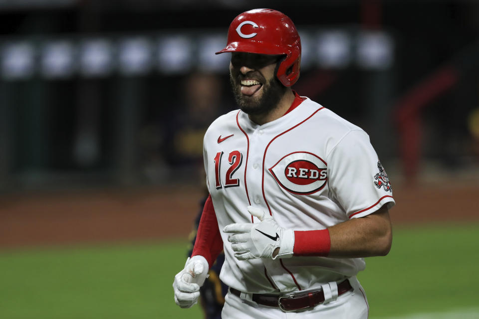 Cincinnati Reds' Curt Casali reacts after hitting a solo home run in the eighth inning during a baseball game against the Milwaukee Brewers in Cincinnati, Monday, Sept. 21, 2020. (AP Photo/Aaron Doster)