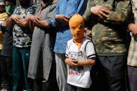 <p>A young masked Kashmiri protester participates in funeral prayers in absentia for rebel commander and his associate killed in a gunbattle, in Srinagar, India, Saturday, May 27, 2017. One civilian was killed and dozens of others injured Saturday after massive anti-India protests and clashes erupted in Indian-controlled Kashmir following the killing of a prominent rebel commander and his associate in a gunbattle with government forces in the disputed region. (Photo: Mukhtar Khan/AP) </p>