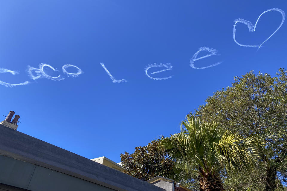The name of Hong Kong singer and songwriter, Coco Lee, is written in the sky above Sydney, Monday, July 31, 2023. Lee was being mourned by family and friends at a private ceremony Tuesday, Aug. 1, 2023 in Hong Kong, a day after fans paid their respects at a public memorial for the Hong Kong-born entertainer who had international success. Lee died July 5 at age 48. (AP Photo/Mark Baker)