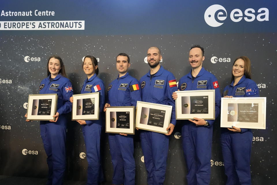 From left, Rosemary Cooga of Britain, Sophie Adenot of France, Raphael Liegeois of Belgium, Pablo Alvarez Fernandez of Spain, Marco Sieber of Switzerland, and Katherine Bennell-Pegg of Australia, from left, hold there certificates at the graduation ceremony of astronaut candidates of the Class of 2022 at the European Astronaut Centre in Cologne, Germany, Monday, April 22, 2024. The new ESA astronauts took up duty at the European Astronaut Centre one year ago to be trained to the highest level of standards as specified by the International Space Station partners. Also concluding a year of astronaut basic training is Australian astronaut candidate Katherine Bennell-Pegg, who has trained alongside ESA's candidates. (AP Photo/Martin Meissner)