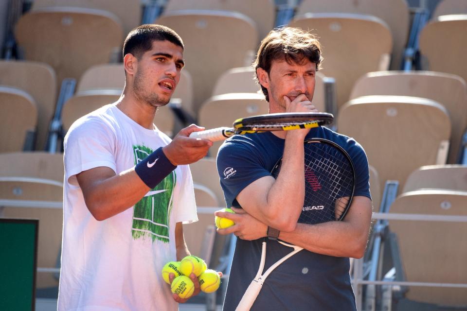 Carlos Alcaraz of Spain with coach Juan Carlos Ferrero during training on Court Philippe Chatrier in preparation for the 2022 French Open Tennis Tournament at Roland Garros