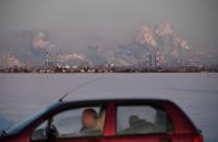 FILE PHOTO: A car drives past the Gazprom Neft's oil refinery in Omsk