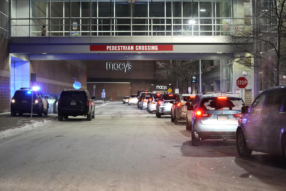 People leave in their cars after a shooting at Mall of America, Friday, Dec. 23, 2022, in Bloomington, Minn. (AP Photo/Abbie Parr)