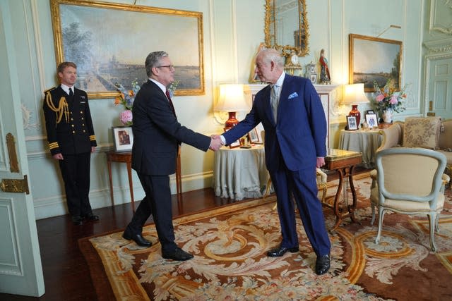 Prime Minister Sir Keir Starmer shakes hands with the King at Buckingham Palace