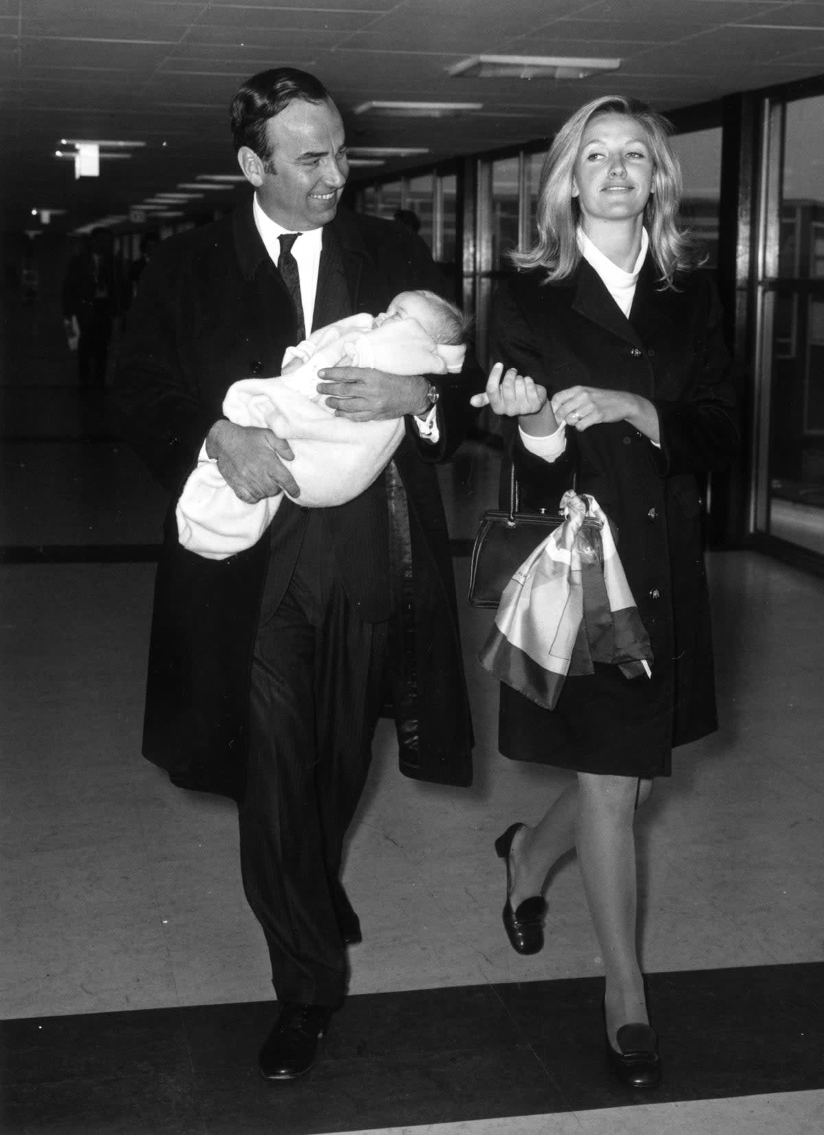 Australian businessman and media tycoon Rupert Murdoch with his wife, Anna and their baby daughter, Elizabeth, at London Airport in 1968 (Getty Images)