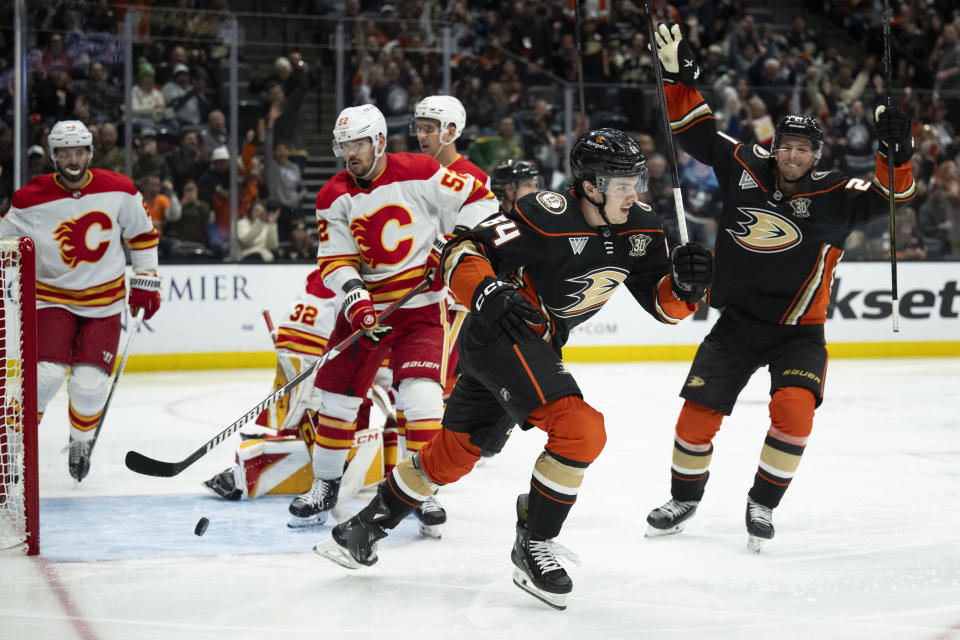 Anaheim Ducks forward Sam Colangelo (64) celebrates his first NHL goal, during the third period of the team's NHL hockey game against the Calgary Flames, Friday, April 12, 2024, in Anaheim, Calif. (AP Photo/Kyusung Gong)