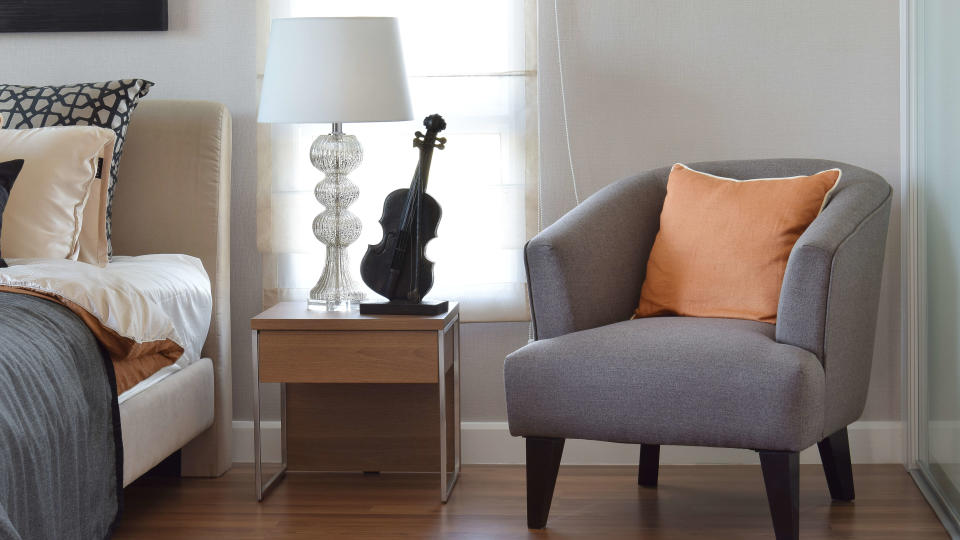 Bedroom setting with single chair in the foreground