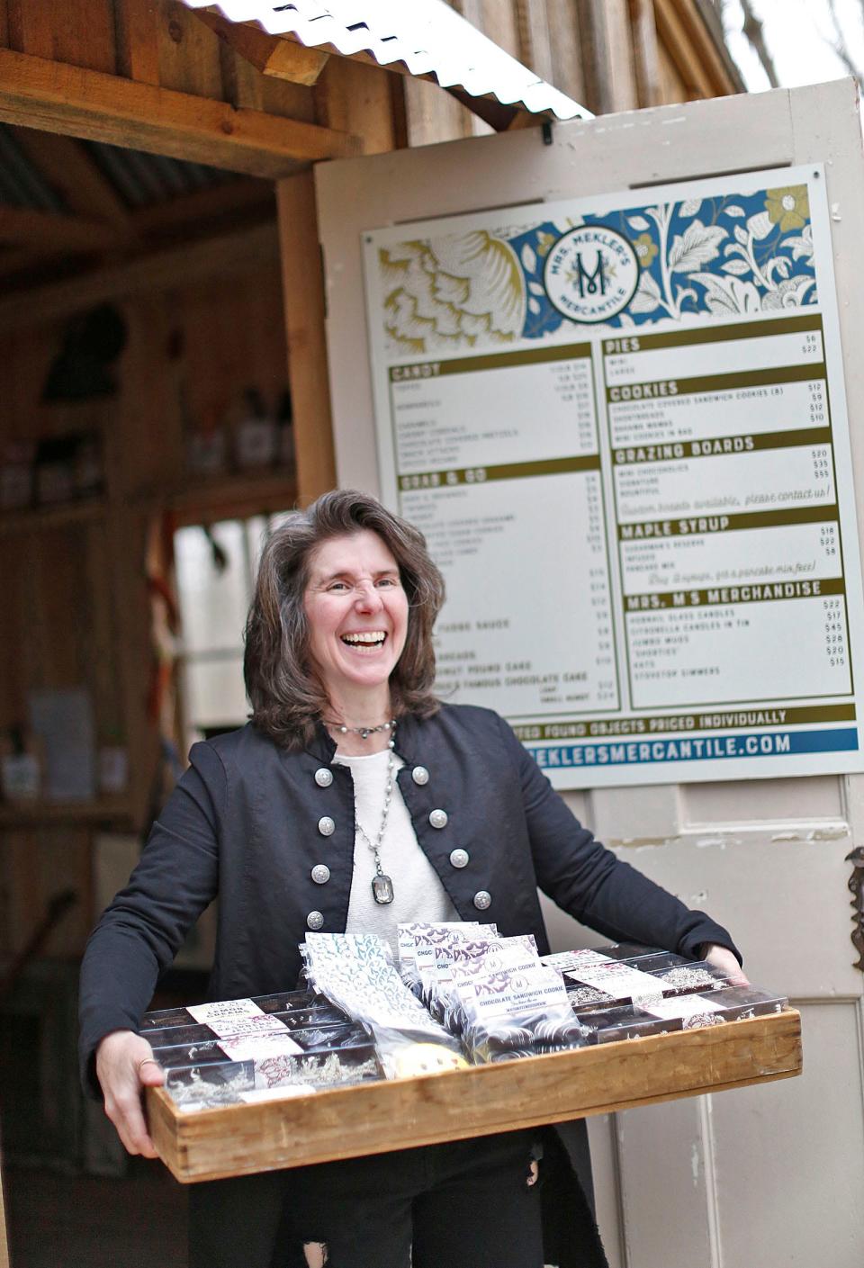 Jennifer Mekler with a load of fresh handmade treats from the Sugar Shack in the Beechwood neighborhood of Cohasset on Tuesday, April 26, 2022.