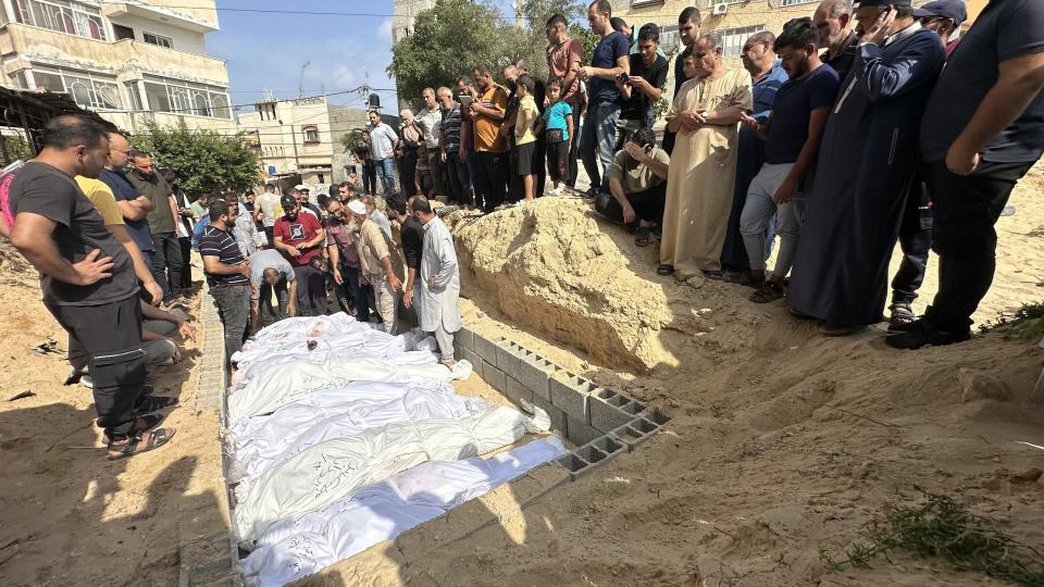 Bodies of Palestinians killed amid ongoing Israeli airstrikes on the Gaza Strip are buried in a mass grave at a cemetery in Deir al-Balah, Gaza, Oct. 23, 2023. / Credit: Doaa Albaz/Anadolu/Getty