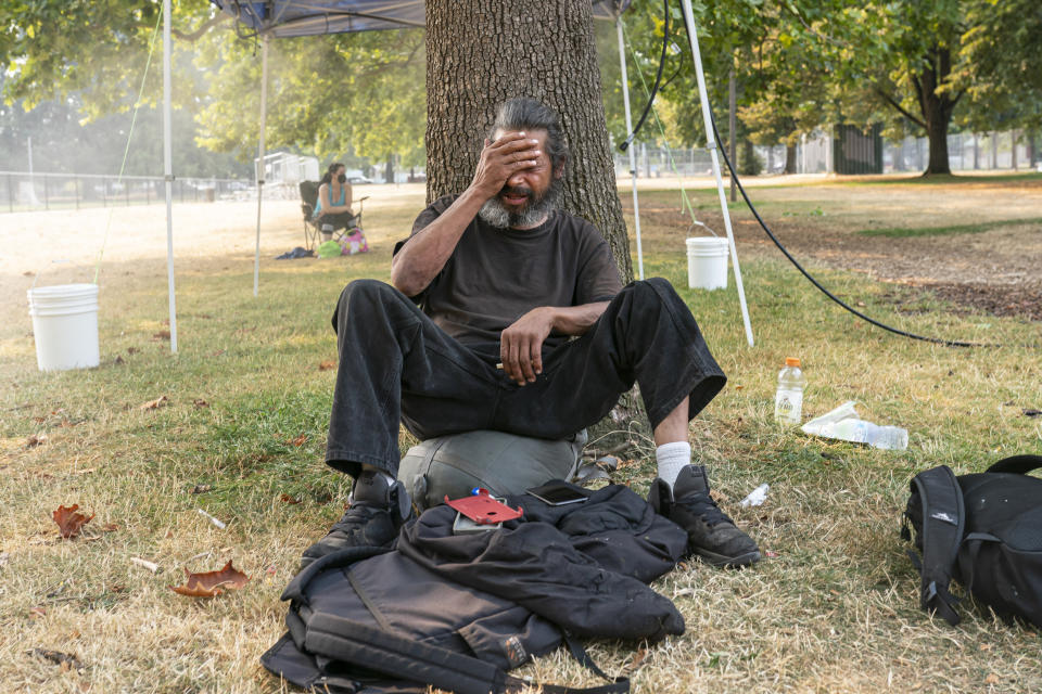 Image: A homeless man near a misting station in Portland, Ore. (Nathan Howard / Getty Images)