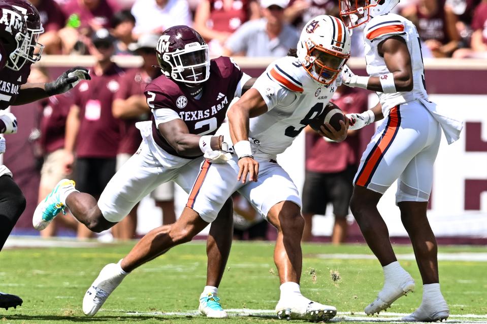 Sep 23, 2023; College Station, Texas; Auburn Tigers quarterback Robby Ashford (9) runs the ball during the third quarter as Texas A&M Aggies defensive back Jacoby Mathews (2) attempts to tackle him at Kyle Field. Maria Lysaker-USA TODAY Sports