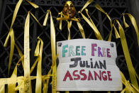 Ribbons and placards are fixed to the entrance gate of the High Court in London, Wednesday, Oct. 27, 2021. The U.S. government is scheduled to ask Britain's High Court to overturn a judge's decision that WikiLeaks founder Julian Assange should not be sent to the United States to face espionage charges. A lower court judge refused extradition in January on health grounds, saying Assange was likely to kill himself if held under harsh U.S. prison conditions. (AP Photo/Frank Augstein)