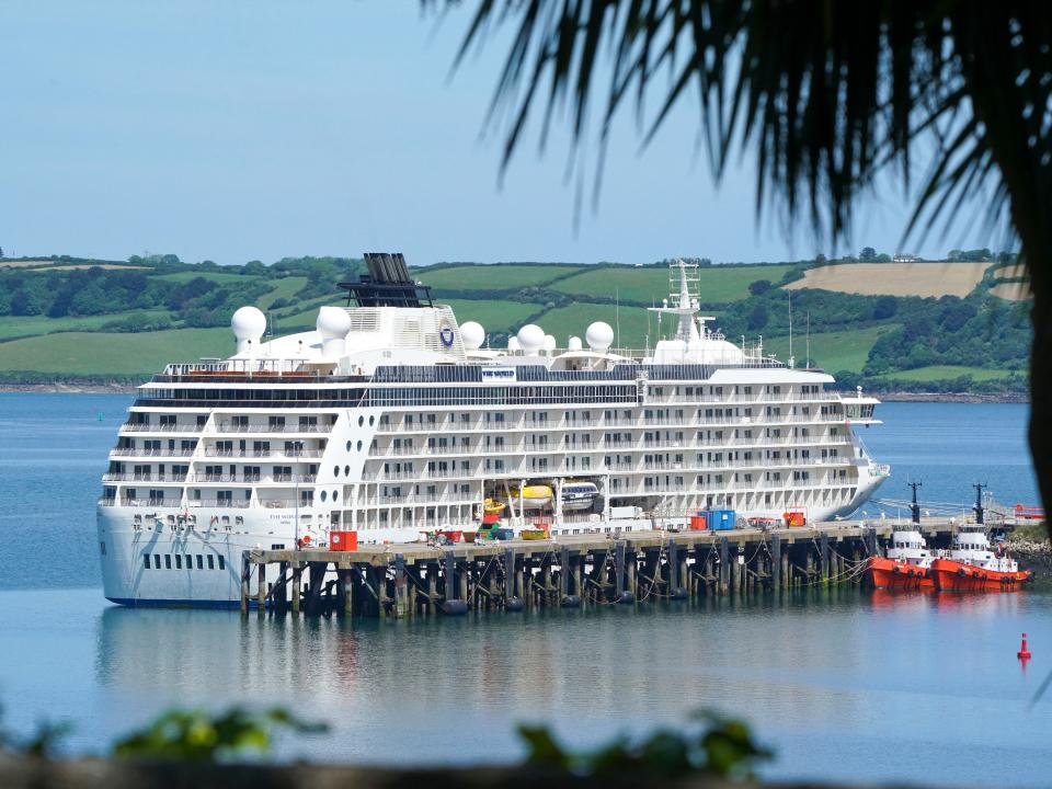 FALMOUTH, UNITED KINGDOM - MAY 26: 'The World' residential cruise liner laid up in Falmouth whilst unable to sail due to the coronavirus pandemic on May 26, 2020 in Falmouth, United Kingdom. 'The World' residential cruise liner, which contains 165 privately owned residences worth more than £4 million each, normally sails around world with 150-200 people on board. The vessel has not had a positive COVID-19 case, but will remain in Falmouth until it is safe to operate once more. (Photo by Hugh Hastings/Getty Images)