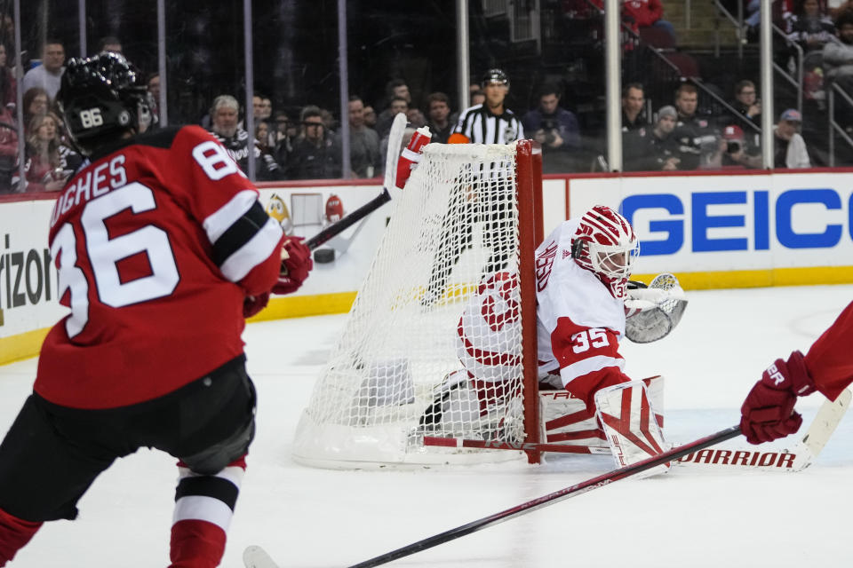 New Jersey Devils' Jack Hughes (86) shoots the puck past Detroit Red Wings goaltender Ville Husso (35) for a goal during the second period of an NHL hockey game Thursday, Oct. 12, 2023, in Newark, N.J. (AP Photo/Frank Franklin II)