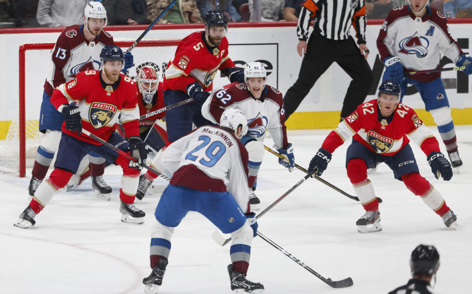 Colorado Avalanche center Nathan MacKinnon (29) prepares to shoot through traffic on Florida Panthers goaltender Sergei Bobrovsky (72), scoring a goal during the second period of an NHL hockey game Saturday, Feb. 11, 2023, in Sunrise, Fla. (AP Photo/Reinhold Matay)