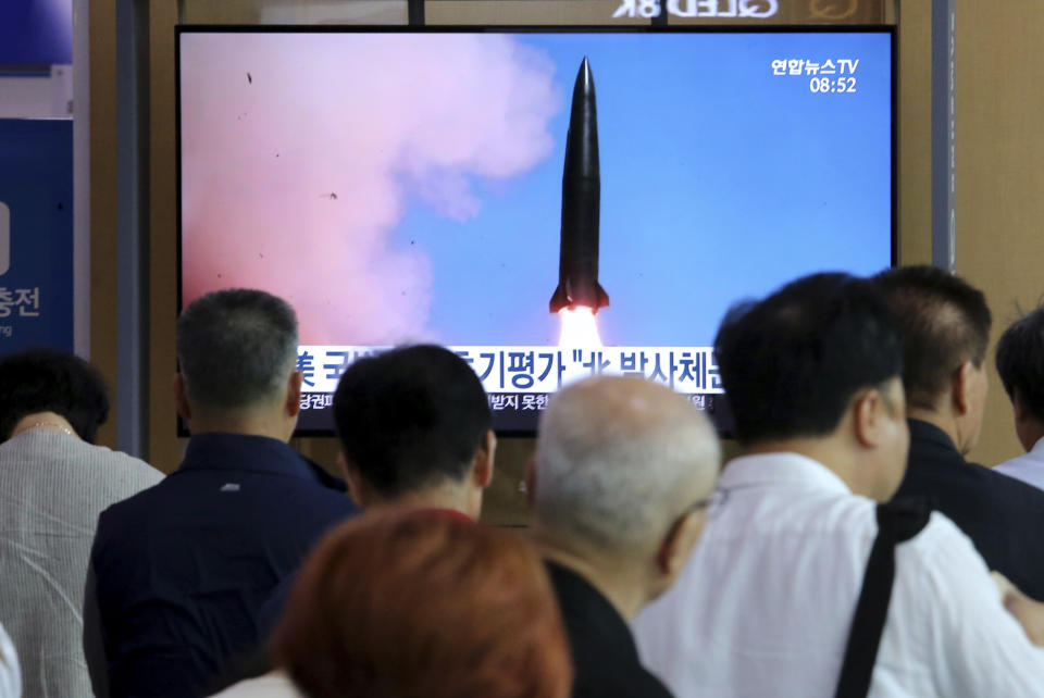 People watch a TV showing a file image of North Korea's missile launch during a news program at the Seoul Railway Station in Seoul, South Korea, Thursday, July 25, 2019. North Korea fired two unidentified projectiles into the sea on Thursday, South Korea's military said, the first launches in more than two months as North Korean and U.S. officials work to restart nuclear diplomacy.(AP Photo/Ahn Young-joon)