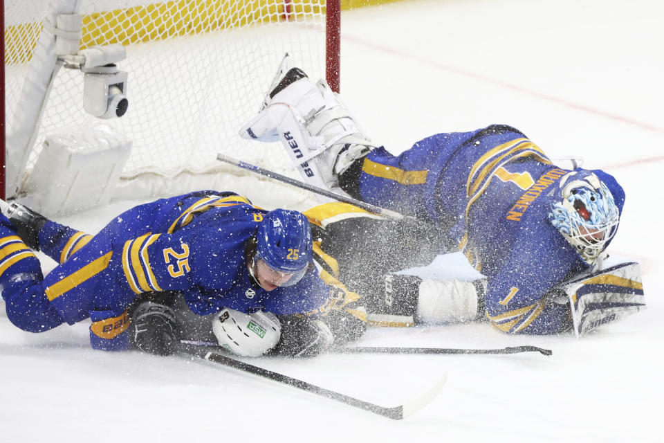 Buffalo Sabres defenseman Owen Power (25) and Pittsburgh Penguins Radim Zohorna (63) collide with Sabres goaltender Ukko-Pekka Luukkonen (1) during the third period of an NHL hockey game Friday, Nov. 24, 2023, in Buffalo N.Y. (AP Photo/Jeffrey T. Barnes)