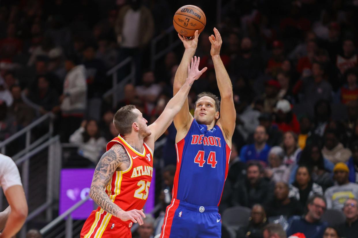 Pistons forward Bojan Bogdanovic shoots over Hawks guard Garrison Mathews in the second half of the Pistons' 130-124 loss on Monday, Dec. 18, 2023, in Atlanta.