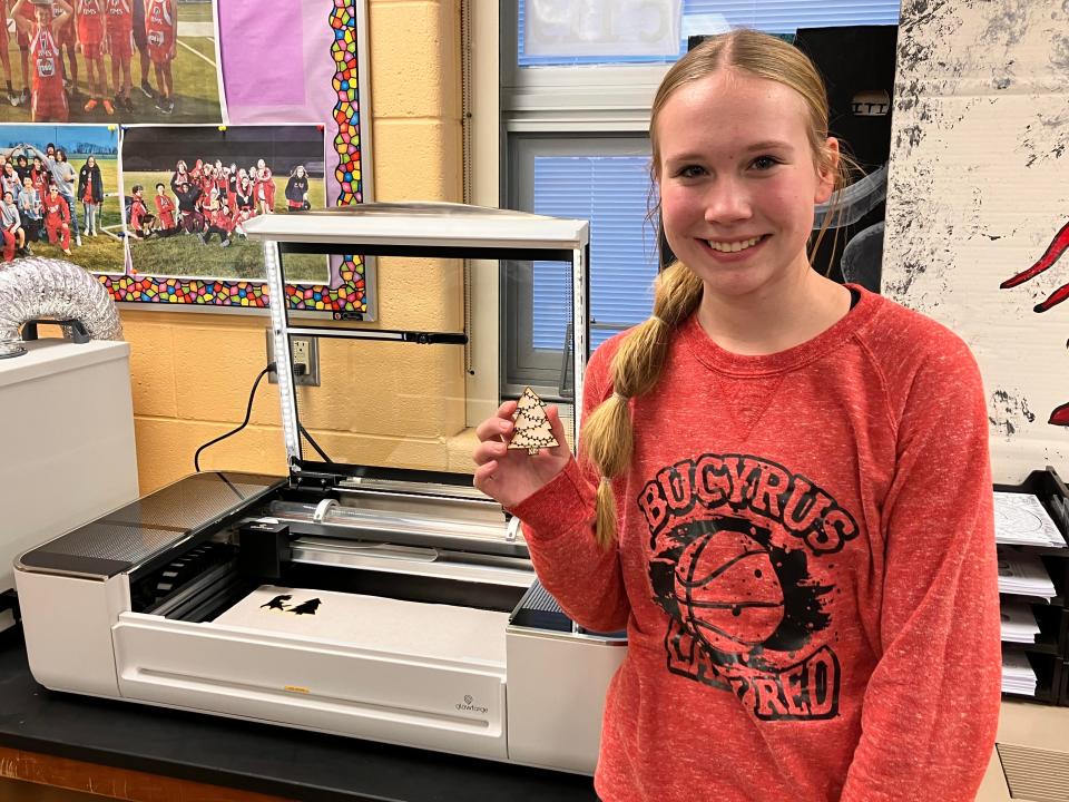 Aubrie Kimmel shows her ornament that had just been removed from the printer.