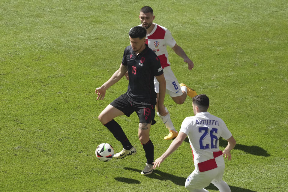 Albania's Mirlind Daku, centre, controls the ball ahead Croatia's Martin Baturina during a Group B match between Croatia and Albania at the Euro 2024 soccer tournament in Hamburg, Germany, Wednesday, June 19, 2024. (AP Photo/Sunday Alamba)