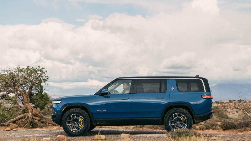 A photo of a blue Rivian R1S. 