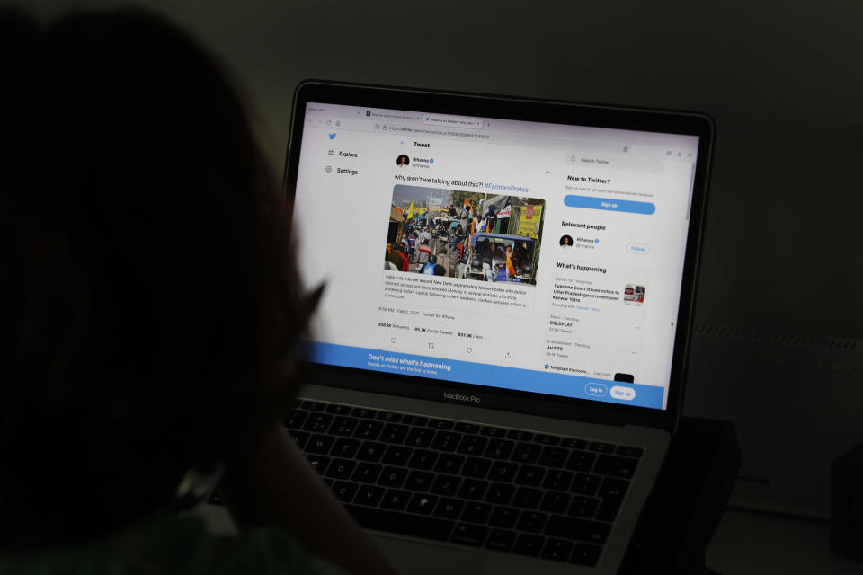 A woman looks at the Twitter page of pop star Rihanna in New Delhi, India, Thursday, July 15, 2021. It began in February with a tweet by Rihanna that sparked widespread condemnation of Indian Prime Minister Narendra Modi’s handling of massive farmer protests near the capital, souring an already troubled relationship between the government and Twitter. Moving to contain the backlash, officials hit Twitter with multiple injunctions to block hundreds of tweets critical of the government. In the same month, the Indian government announced the new rules, in the works for years, that apply to social media companies, streaming platforms and digital news publishers. (AP Photo/Manish Swarup)