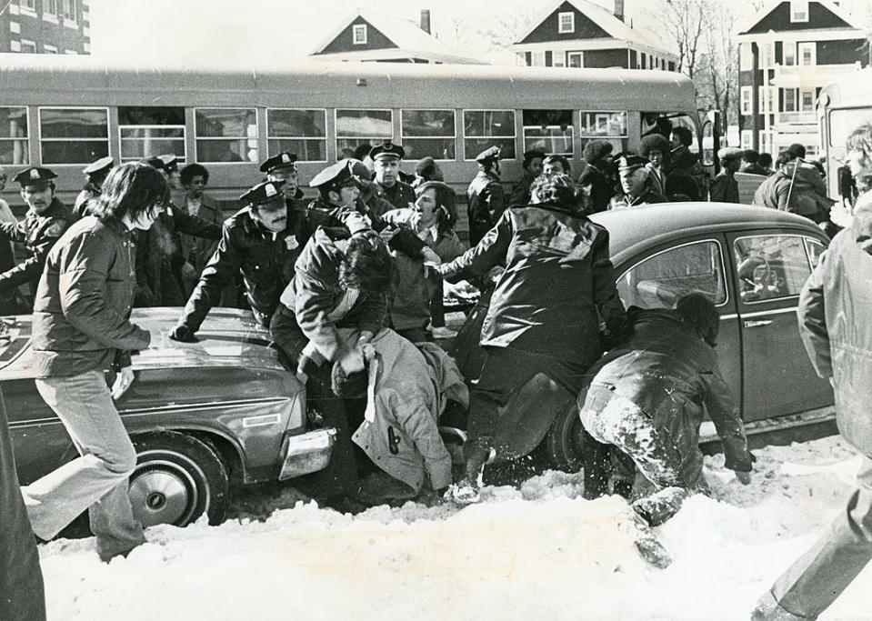 Police step in as a fight between students erupts in front of Hyde Park High School in Boston Feb. 14, 1975. An initiative to desegregate Boston Public Schools was implemented in the fall of 1974 and was met with strong resistance from many city residents. (Paul Connell / Getty Images)