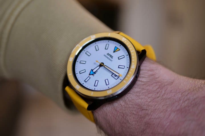 A person wearing the Xiaomi Watch S3 with yellow strap and bezel.