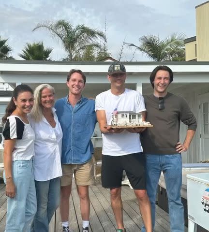<p>Ashton Kutcher/Instagram</p> Mila Kunis and Ashton Kutcher posing with their Airbnb guests at their Santa Barbara home.