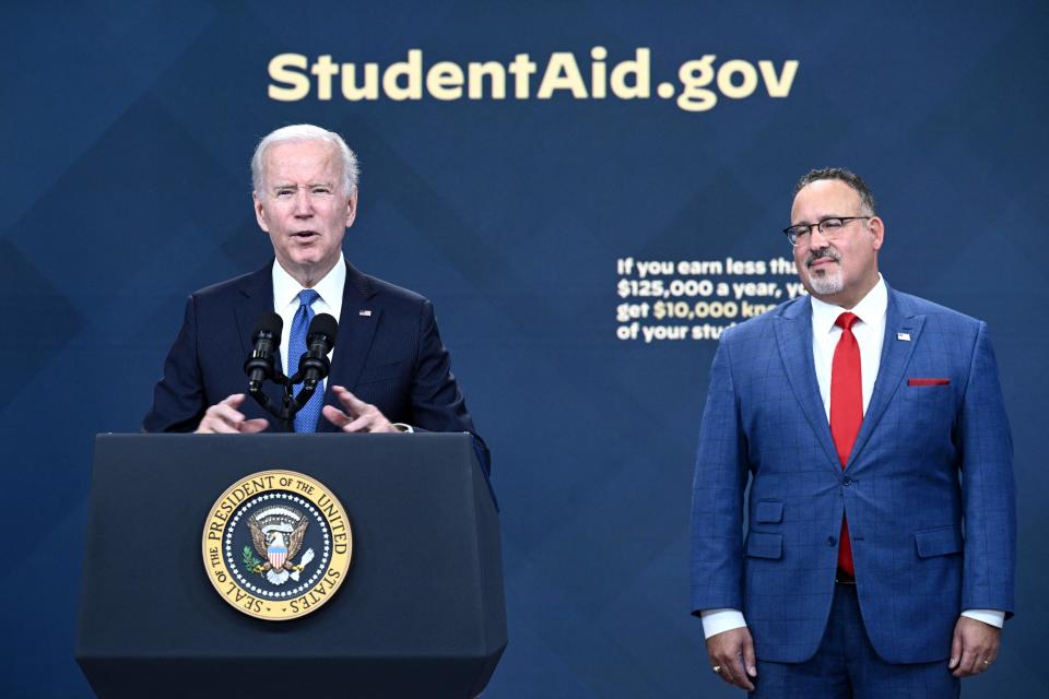 US Education Secretary Miguel Cardona (R) looks on as US President Joe Biden delivers remarks on the student debt relief portal beta test, in the South Court Auditorium of the Eisenhower Executive Office Building, next to the White House, in Washington, DC, on October 17, 2022. (Photo by Brendan SMIALOWSKI / AFP) (Photo by BRENDAN SMIALOWSKI/AFP via Getty Images)