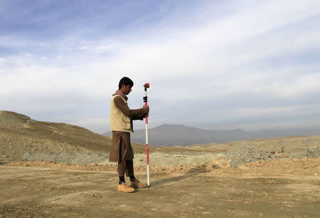 A man works at a road construction site, which is being built by a Chinese company, in Khogyani district of Nangarhar province November 19, 2015. REUTERS/Parwiz