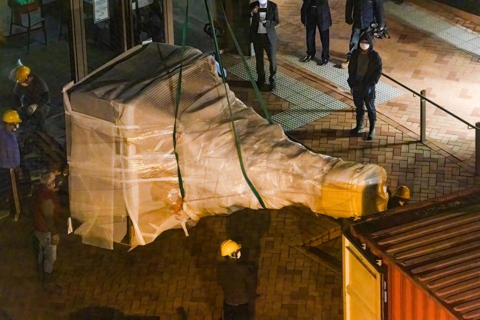 The lower-half of the statue was hanged by the crane and ready to be moved inside the container for transportation. Authorities in Hong Kong tore down a public sculpture dedicated to the victims of the Tiananmen Square massacre, accelerating a campaign to erase the crackdown from public recollection and stamp out dissent in a city that until recently was one of Asias freest. / Credit: Alex Chan/SOPA Images/LightRocket via Getty Images