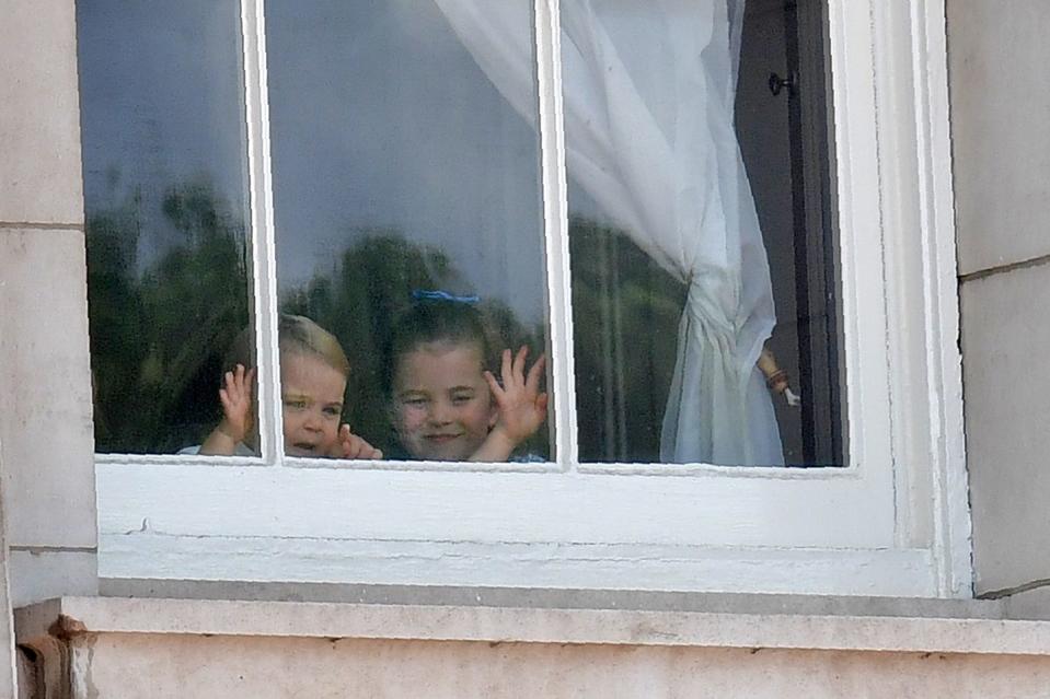 Prince Louis and Princess Charlotte waving from the window.