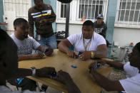 Tenants play dominoes outside an apartment building at the Imperial Courts housing project in the Watts neighborhood of Los Angeles, Wednesday, June 17, 2020. (AP Photo/Jae C. Hong)
