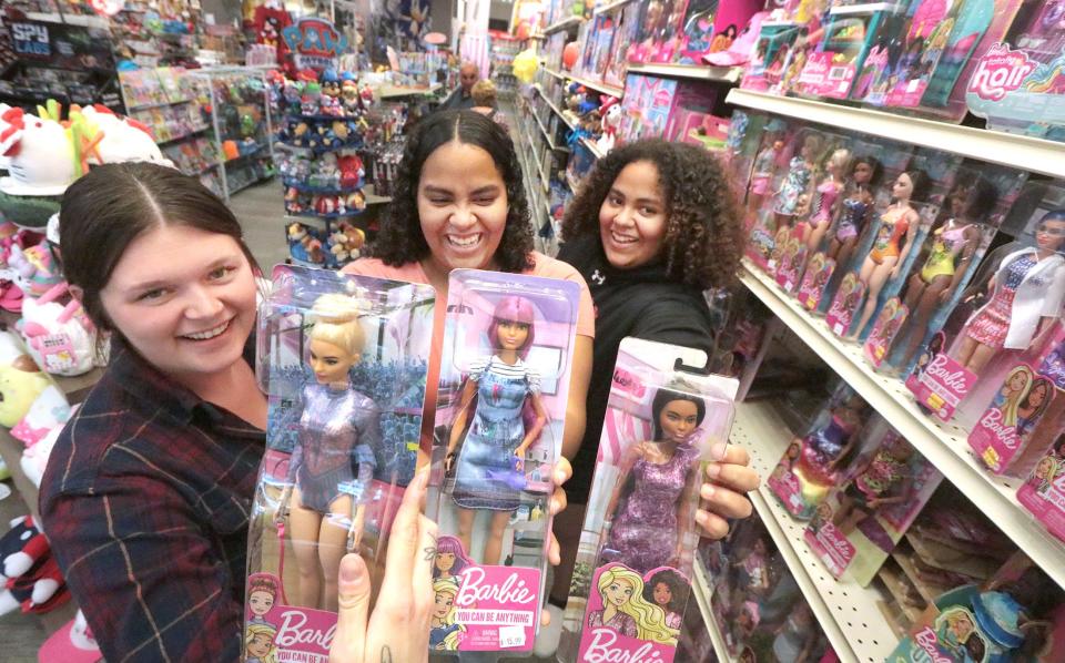 Shoppers Lynzee Conkle, Lilly Bush and Lainey Bush check out the Barbie doll selection at Destination Fun toy store at Tanger Outlets mall in Daytona Beach. Barbie is a hot item this holiday season, said store owner Kevin Kasch.