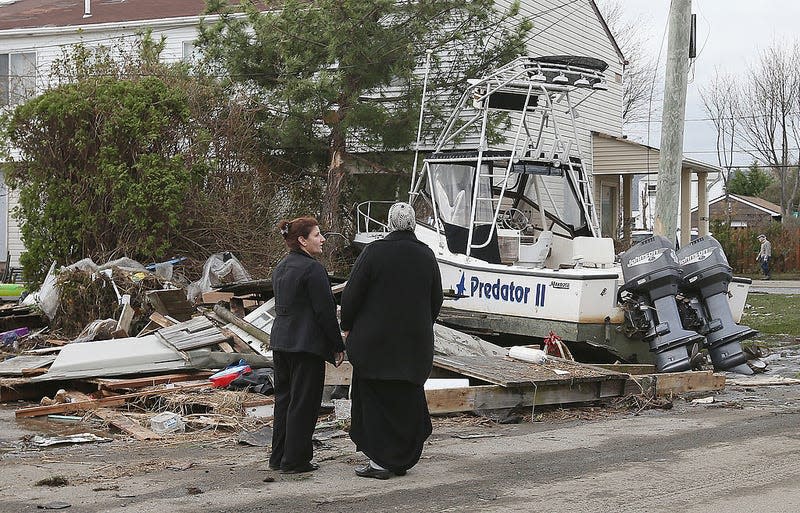 Residents take a break during cleanup operations following Hurricane Sandy on October 31, 2012 in Lindenhurst, New York. 