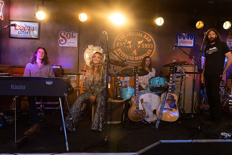 a group of people including lainey wilson on a stage