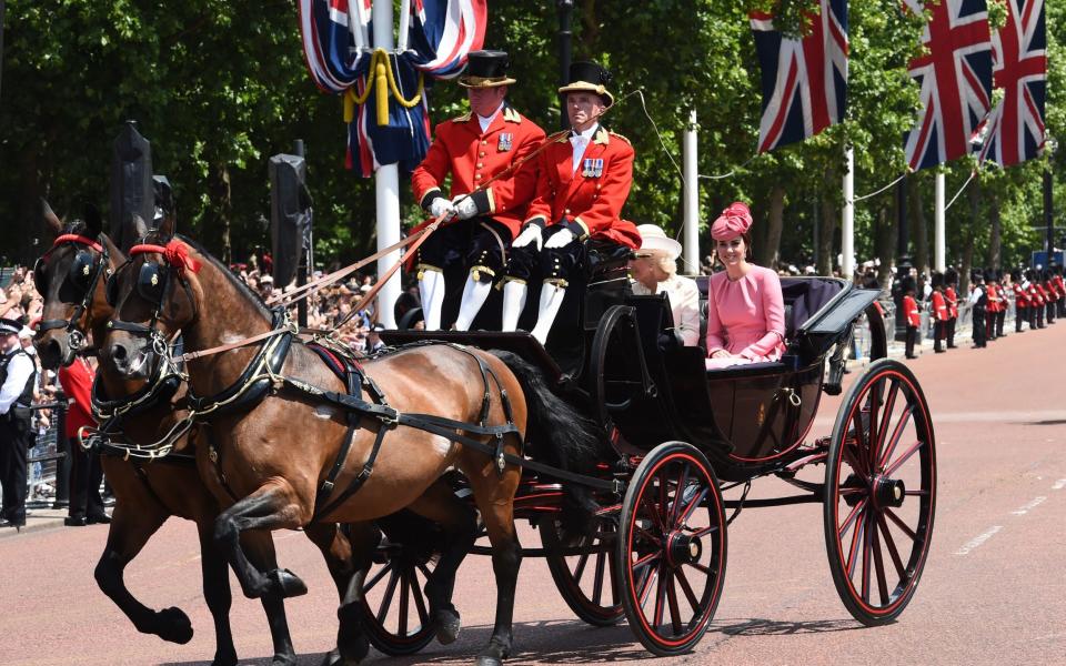 Catherine, Duchess of Cambridge and Camilla, Duchess of Cornwall travel down the Mall in an open carriage drawn by Cleveland Bays