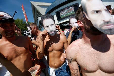 Soccer Football - World Cup - England fans watch Sweden vs England - Bristol, Britain - July 7, 2018 England fans with masks of England manager Gareth Southgate outside Ashton Gate Stadium Action Images via Reuters/Ed Sykes