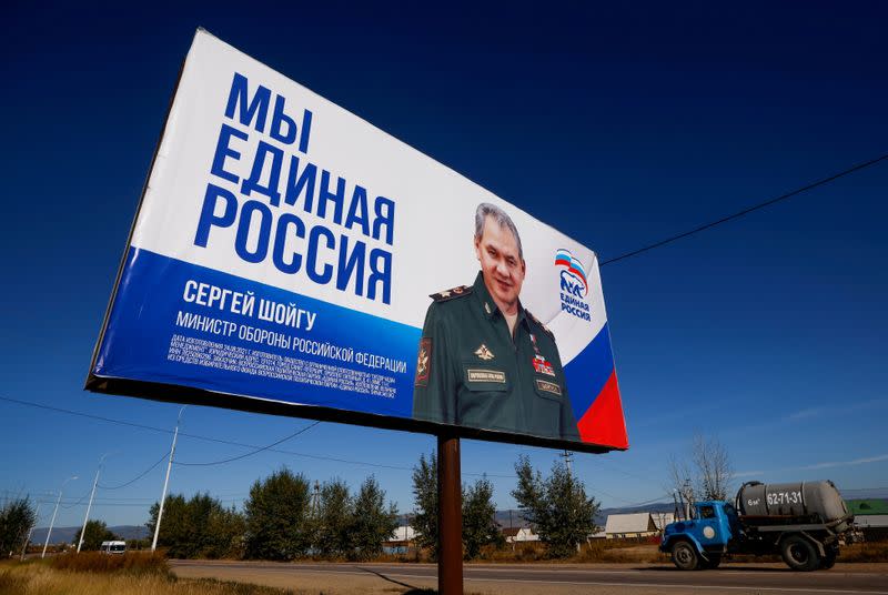 FILE PHOTO: Truck drives past a campaign poster of the United Russia political party ahead of the Russian parliamentary and regional election outside Ulan-Ude