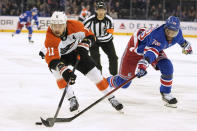 Philadelphia Flyers right wing Travis Konecny (11) skates against New York Rangers defenseman K'Andre Miller (79) during the first period of an NHL hockey game Thursday, April 11, 2024, at Madison Square Garden in New York. (AP Photo/Mary Altaffer)