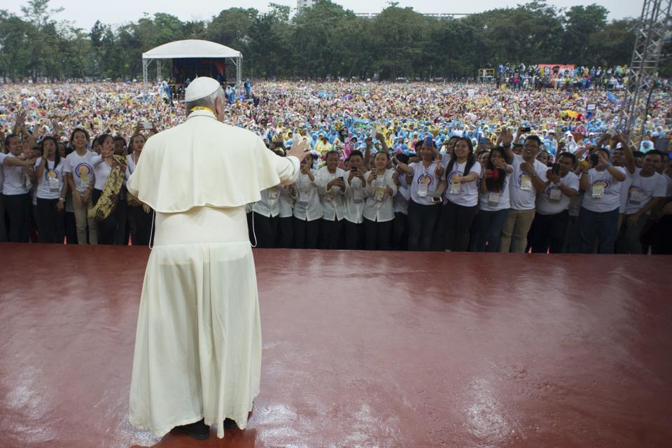 Pope Francis is greeted during a meeting with youths at a Catholic university in Manila January 18, 2015. Pope Francis left the Philippines on Monday, ending a week-long trip to Asia that culminated with a rain-soaked Mass for about seven million people in the capital of Asia's most populous Catholic nation, the largest-ever crowd for a papal event. Picture taken January 18, 2015. REUTERS/Osservatore Romano (PHILIPPINES - Tags: RELIGION) ATTENTION EDITORS - THIS PICTURE WAS PROVIDED BY A THIRD PARTY. REUTERS IS UNABLE TO INDEPENDENTLY VERIFY THE AUTHENTICITY, CONTENT, LOCATION OR DATE OF THIS IMAGE. FOR EDITORIAL USE ONLY. NOT FOR SALE FOR MARKETING OR ADVERTISING CAMPAIGNS. NO SALES. NO ARCHIVES. THIS PICTURE IS DISTRIBUTED EXACTLY AS RECEIVED BY REUTERS, AS A SERVICE TO CLIENTS