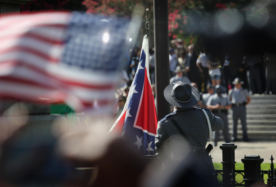 A South Carolina state police honor guard lowers the Confederate flag from the Statehouse grounds on July 10, 2015 in Columbia, South Carolina. Republican Governor Nikki Haley presided over the event after signing the historic legislation to remove the flag the day before. 