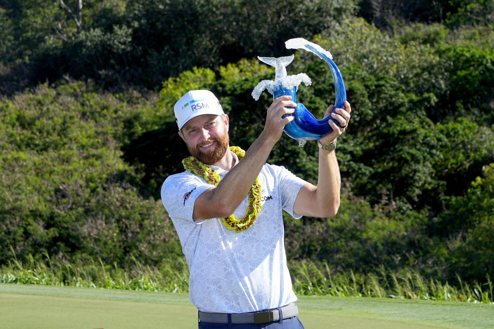 Chris Kirk holds the champions trophy after the final round of The Sentry golf event, Sunday, Jan. 7, 2024, at Kapalua Plantation Course in Kapalua, Hawaii. (AP Photo/Matt York)